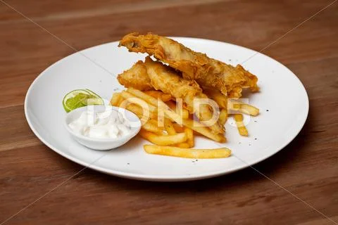 Shrimp tempura dish with white sauce and fried potatoes Stock Photos