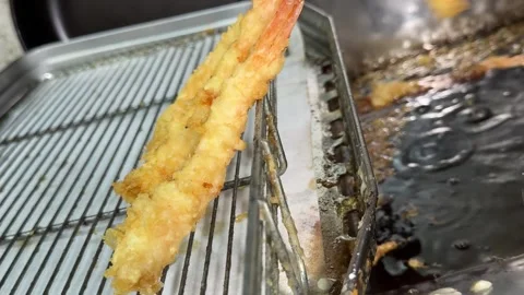 Shrimp Tempura on a Wire Rack beside the Fryer, Traditional Japanese Food Stock Footage 345789035