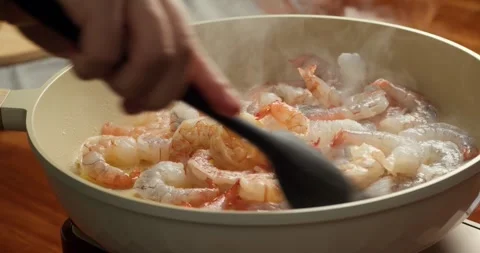 Shrimp turning orange while cooking in pan close up doneness process Stock Footage 335339221