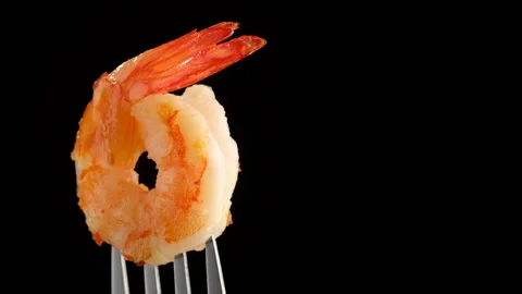 Shrimps on fork rotating closeup macro. black background place for text Stock Footage 132550120