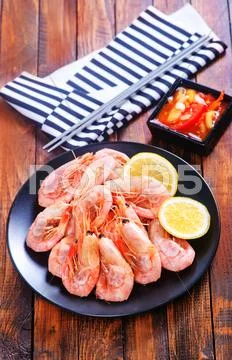 Shrimps on plate on a table Stock Photos