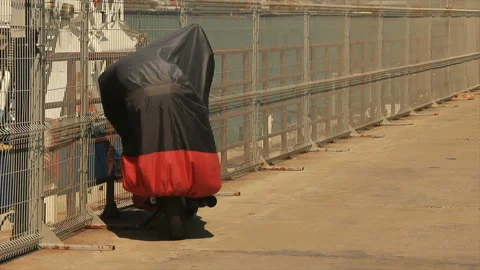 Shrouded motorcycle on quay Stock Footage 149205205