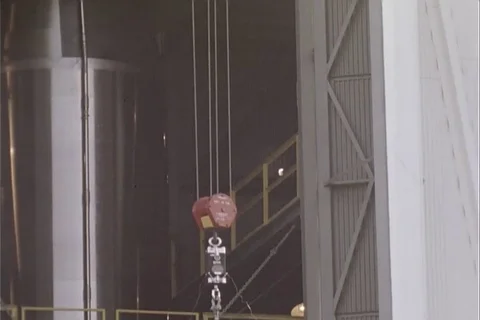 Shrouded satellite being hoisted up side... | Stock Video | Pond5