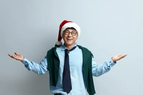 Shrugging Man Smiling Studio. Guy in Santa Claus Hat Standing Raising Hands Stock Photos