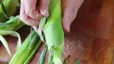 Shucking corn overhead view Stock Footage 79228760