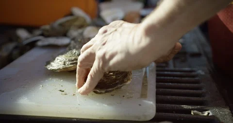 Shucking fresh oysters on cutting board 1 Stock Footage 123786189