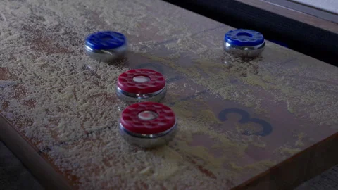 SHUFFLE BOARD BUMP SHOT.  4K ECU. SLOW MOTION AT 60 FPS. NO PEOPLE. Stock Footage 246611449