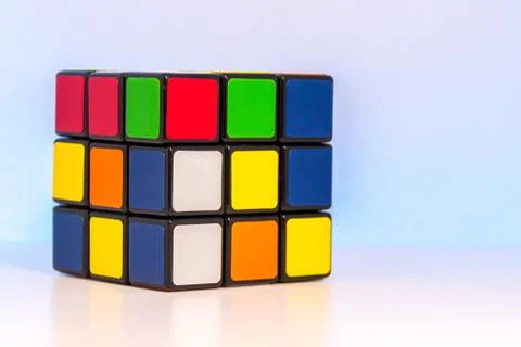 Shuffled Magic Cube for problem-solving on light blue background Stock Photos