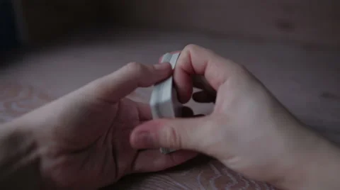 Shuffled playing cards in their hands Stock Footage 59774859