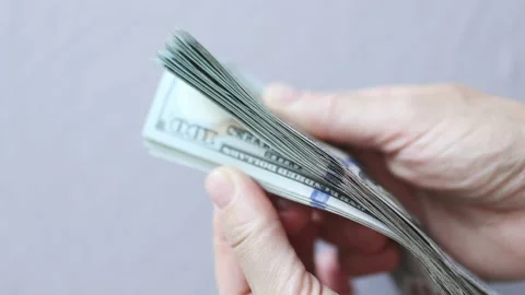 Shuffling stack pack of hundred 100 dollar bills on light grey background Vídeo Stock 164187148