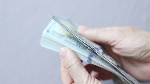 Shuffling stack pack of hundred 100 dollar bills on light grey background Vídeo Stock 165789980