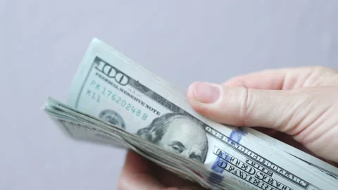 Shuffling stack pack of hundred 100 dollar bills on light grey background Video stock 166423210