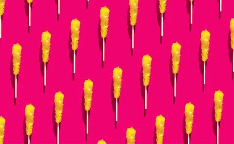 Shugar yellow candy pattern flat lay on Raspberry Sorbet background. Christmas Stock Photos