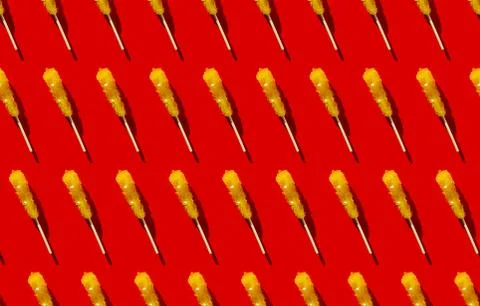 Shugar yellow candy seamless pattern flat lay on red background. Christmas, new Stock Photos