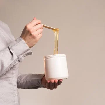 Shugaring paste stretched with spatula upwards vertical frame Stock Photos