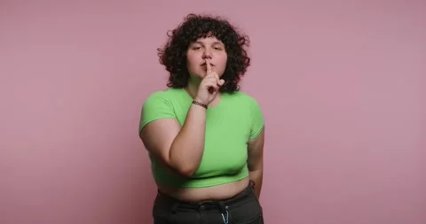 Shushing action in different frames with a person on a pink background Stock Footage 331990716