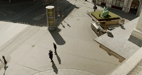 Shutdown in Vienna, Austria - tracking shot, top shot of two policemen Stock Footage 128699152