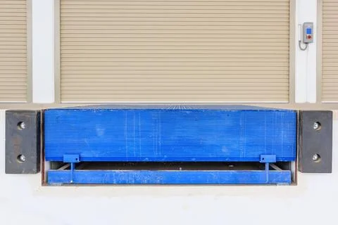 Shutter door or roller door and dock leveler outside factory building use f.. Stock Photos