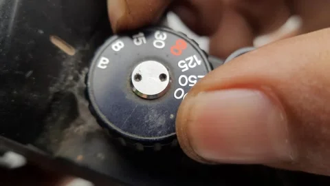 Shutter Speed Dial of Vintage Camera Adjusted by Hand in Macro Shot Stock Footage 310142899