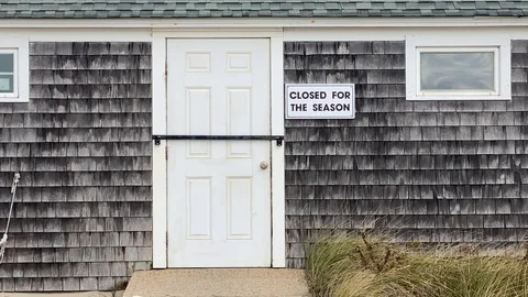 Shuttered up Building in the Off Season on Cape Cod with Beach Grass Stock Footage 119430019