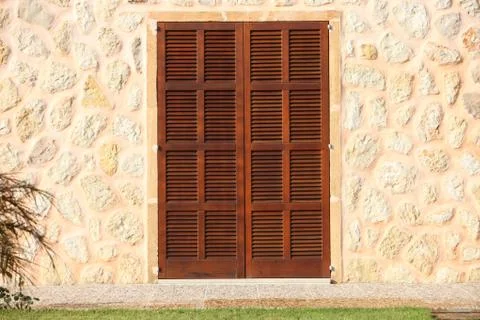 Shuttered window in a stone building Stock Photos