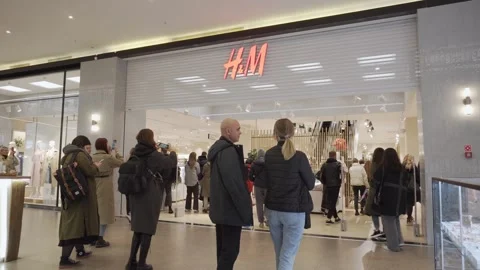 Shutters of HM store open during black friday in mall, wide shot. Video stock 246944617