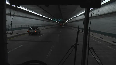 SHUTTLE BUS DRIVNG THROUGH TUNNEL Video stock 37169496