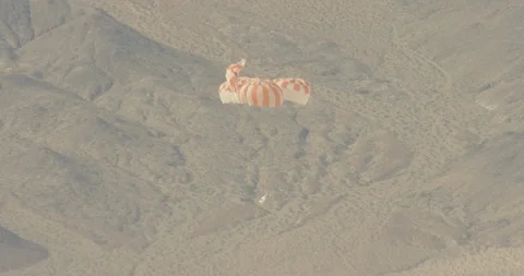 Shuttle parachuting back down to earth, drone, helicopter aerial 動画素材 115316064