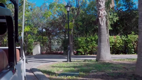 The shuttle smoothly cruises through the manicured grounds of a luxury hotel Stock Footage 322511978