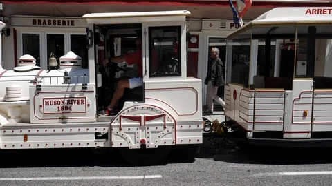 Shuttle train passing though town, tourists 스톡 동영상 112248472