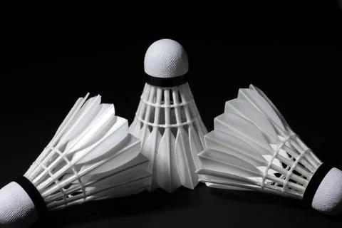 Shuttlecock on a black background. Stock Photos
