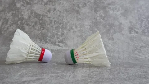 Shuttlecock falling on abstract gray background Stock Footage 336951215
