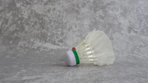Shuttlecock falling on abstract gray background Stock Footage 336951223