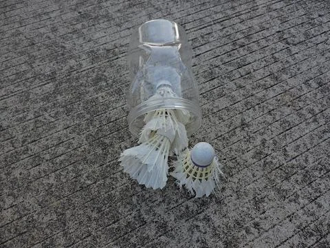 Shuttlecocks on Rough Concrete Ground with Plastic Container Stock Photos