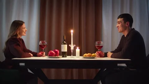 Shy couple first date. Romantic candlelit dinner home. Anniversary celebration. Stock Footage 327715336