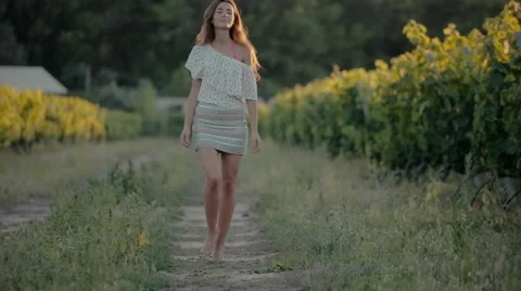 Shy girl goes along the grape rows Stock Footage 59330129