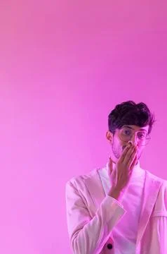 Shy guy oops gesture pink neon blowing air kiss Stock Photos