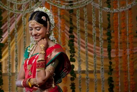 Shy Indian bride looking down and smiling Stock Photos