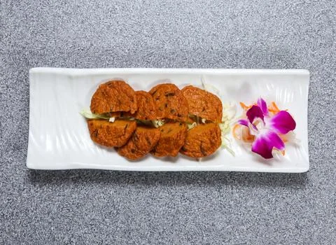 Siamese fish cake served in dish isolated on grey background top view of ho.. Stock Photos