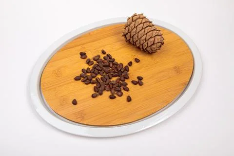 Siberian cones fruit - pine nuts on a kitchen cutting board Stock Photos