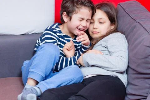 Sibling playing on bed 스톡 사진