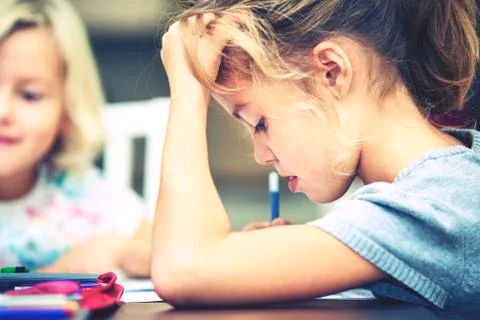 Siblings are doing his homework for elementary school. Stock-Fotos