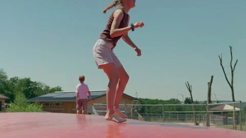 Siblings are Jumping on the Trampoline 스톡 동영상 345595097