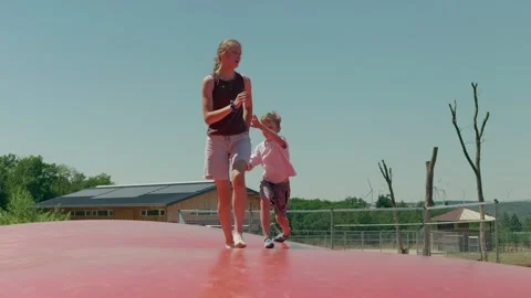 Siblings are Jumping on the Trampoline Slow Motion Stock-Footage 345711327