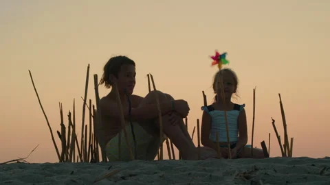 Siblings constructing bamboo enclosure at sunset Stock Footage 252734936