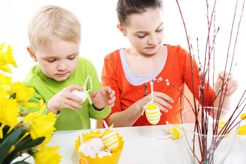 Siblings decorates Easter eggs  Stock Photos