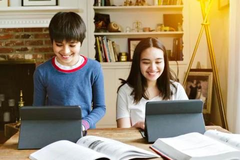 Siblings do their school work from home during social distancing - Homeschool Stock Photos