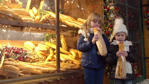 Siblings eating bread near bakery in evening Stock Footage 143505708