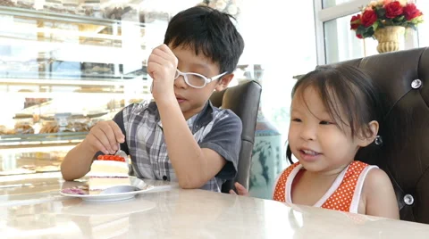 Siblings eating cake together Stock Footage 63766741