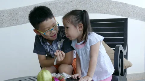 Siblings eating fruit together Stock Footage 68223350